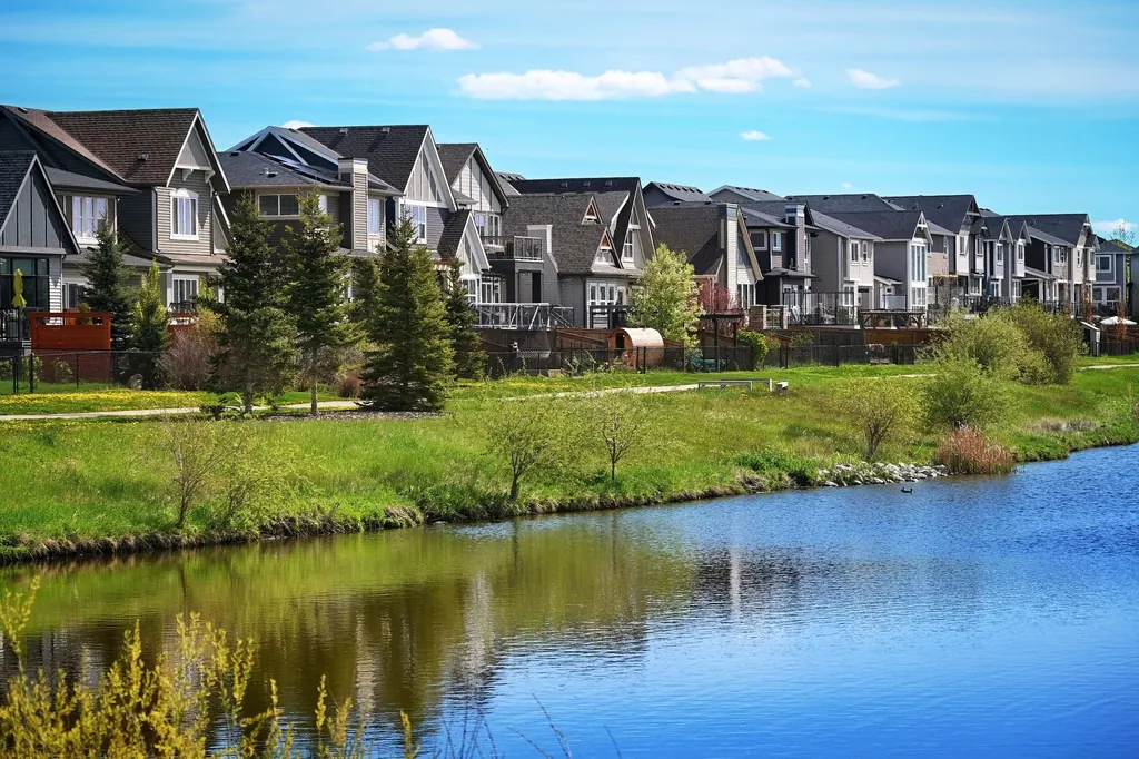 Suburban homes around a quiet pond in Airdrie, Alberta