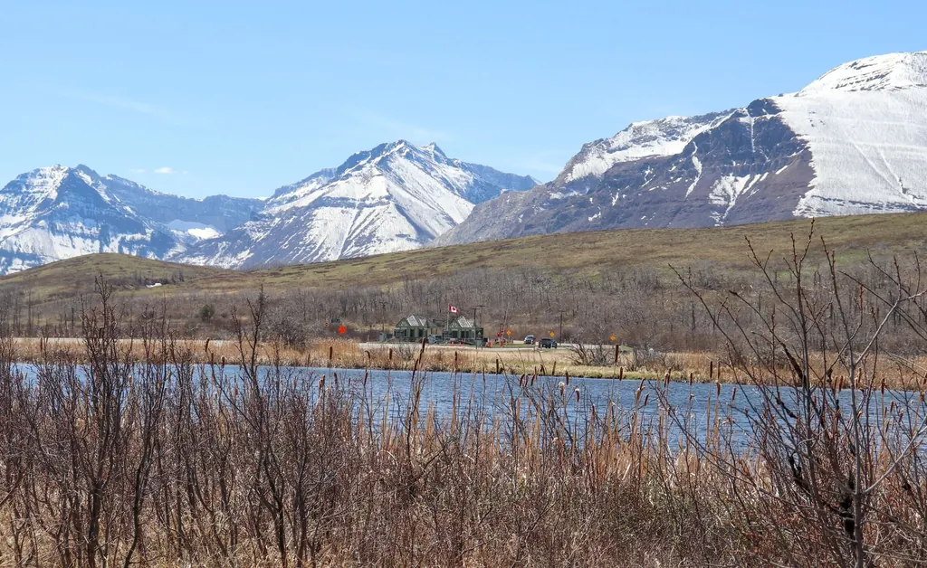 Rocky Mountain foothills and a calm lake southwest of Okotoks