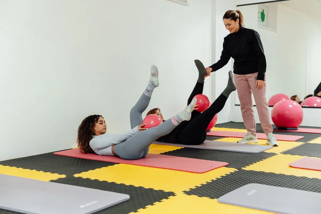 Instructor guiding women through core rehabilitation exercises